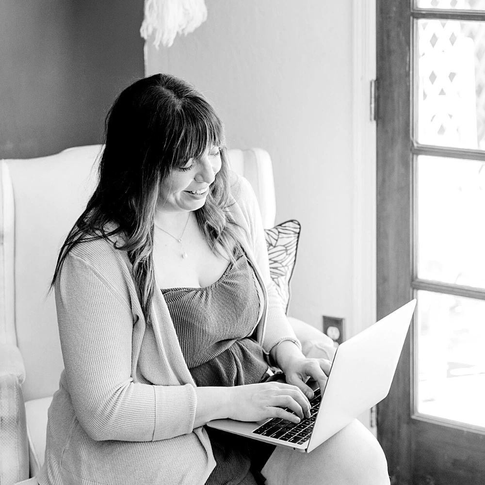 female blogger typing on laptop