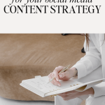 woman in a white suit holding a gold pen