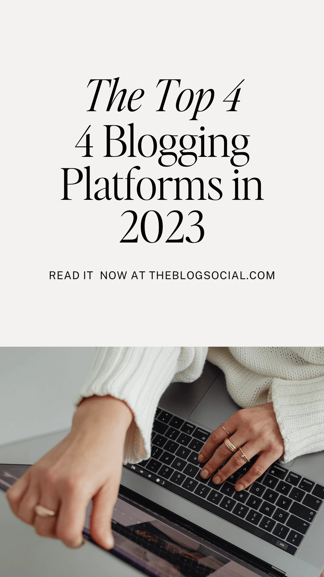 woman in white sweater and gold rings typing on laptop