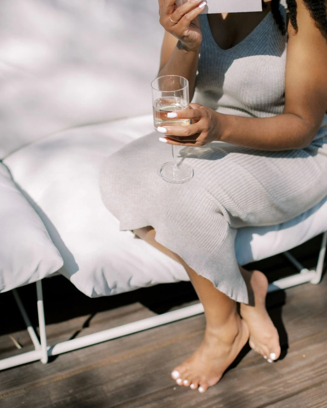woman sitting on couch holding white woman sitting on couch holding white