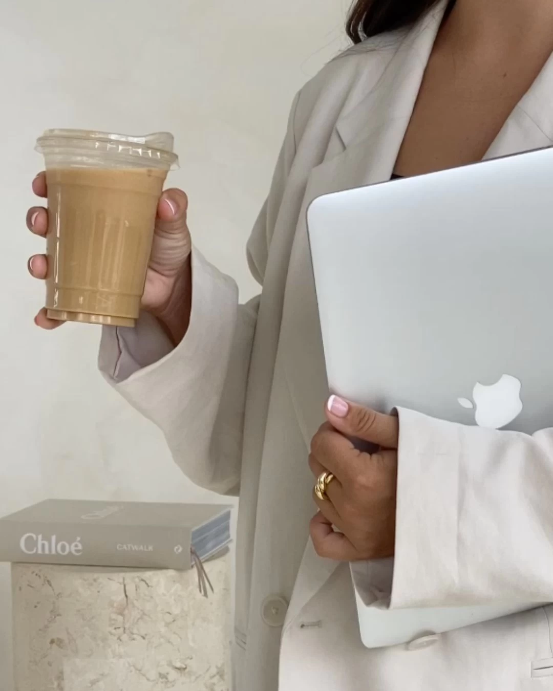 woman with coffee and laptop in hand woman with coffee and laptop in hand