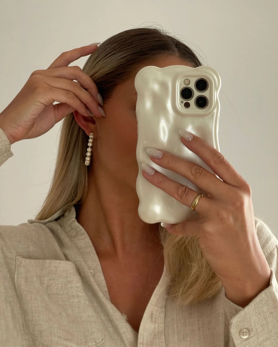 girl holding phone taking selfie