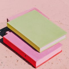 A modern editorial photograph of two or three identical neutral notebooks or folders stacked neatly on a clean surface. The framing is tight and graphic, with the stack pushed toward one side of the frame. Lighting is soft and controlled, slightly desaturated. The image feels composed, calm, and intentional, like a fashion magazine’s take on productivity no people, no text, no borders. --ar 3:4 --profile cdolety --v 7 Job ID: 706d063d-b9c2-40da-bb82-5e3ba25f23a7
